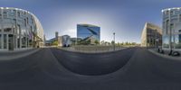 three buildings, two bicycles and one scooter in a 360 - view lens