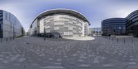 a circular building with a clock in the center of it, reflecting the building's architecture