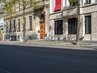 a person walking a dog on the sidewalk with the city in the background and the front door