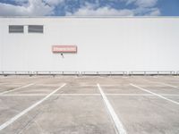 an empty parking lot near some very large buildings as if they were the only space to be left