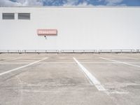 an empty parking lot near some very large buildings as if they were the only space to be left