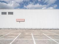 an empty parking lot near some very large buildings as if they were the only space to be left