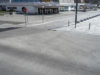 a picture of a parking lot next to an empty street and road with cars parked along it