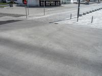 a picture of a parking lot next to an empty street and road with cars parked along it