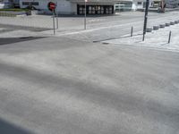 a picture of a parking lot next to an empty street and road with cars parked along it