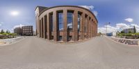 a 360 - vision view of the architecture of a round building next to a street