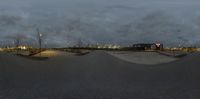 skateboarding at a skateboard park with a snow bank and lights in the background