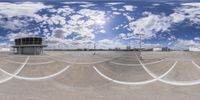 a 360 camera image showing the reflection of clouds and blue sky in a skateboard park