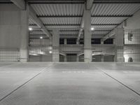 a man standing in a car garage with metal floors, with numbers on them, that spell parking lot