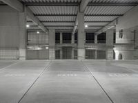 a man standing in a car garage with metal floors, with numbers on them, that spell parking lot