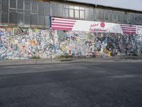 the city side of a building covered in grafitti paper and a large american flag