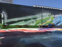 an outdoor painting area painted with colored lines on concrete walls, chairs, and a window