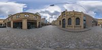 a fisheye lens of a town street with buildings on either side of the street