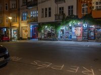 an empty city street at night in front of a bookstore shop with the words sex and hate written on the pavement