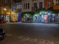 an empty city street at night in front of a bookstore shop with the words sex and hate written on the pavement