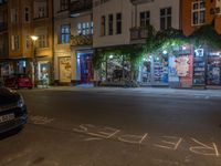 an empty city street at night in front of a bookstore shop with the words sex and hate written on the pavement