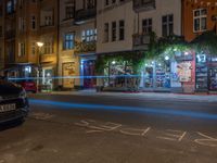 an empty city street at night in front of a bookstore shop with the words sex and hate written on the pavement