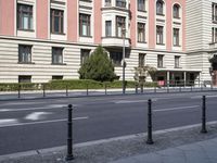 the man in the yellow shirt is walking on the street in front of a building