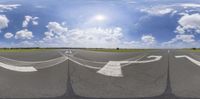 the sky is partly full with clouds in it and no other clouds, in front of a runway