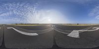 an upside down image of a runway and the sun is shining in the sky above it