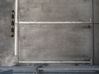 an overhead view shows an empty parking garage in a warehouse building, with yellow safety markers on the floor