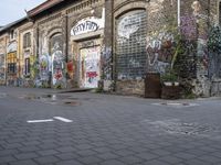 an old building is covered with graffiti on a city street in a town center area