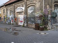 an old building is covered with graffiti on a city street in a town center area