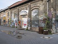 an old building is covered with graffiti on a city street in a town center area