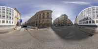 a reflection view of buildings on the side of a road from a fish eye lens