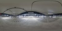 a train station with a lot of empty platforms and stalls below them on concrete floors