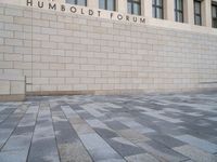 the wall that says humbold forum, with the bricks in front of it