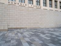 the wall that says humbold forum, with the bricks in front of it