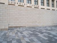 the wall that says humbold forum, with the bricks in front of it