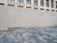 the wall that says humbold forum, with the bricks in front of it