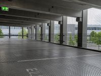 an empty parking lot, with lots of windows and signage above the parking area, with a fire hydrant sign, on the floor