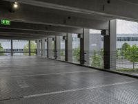 an empty parking lot, with lots of windows and signage above the parking area, with a fire hydrant sign, on the floor