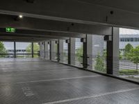 an empty parking lot, with lots of windows and signage above the parking area, with a fire hydrant sign, on the floor