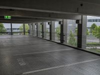 an empty parking lot, with lots of windows and signage above the parking area, with a fire hydrant sign, on the floor