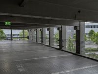 an empty parking lot, with lots of windows and signage above the parking area, with a fire hydrant sign, on the floor