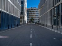 the empty street with bicycles parked in front of the buildings has a sign that says the library on it