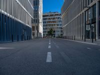 the empty street with bicycles parked in front of the buildings has a sign that says the library on it