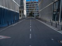 the empty street with bicycles parked in front of the buildings has a sign that says the library on it