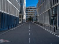 the empty street with bicycles parked in front of the buildings has a sign that says the library on it