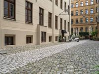 cobblestone stone street in a european city area with an old red fire hydrant