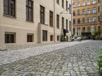 cobblestone stone street in a european city area with an old red fire hydrant