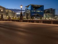 the city skyline is at night from the street level with traffic and pedestrians walking on it