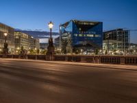 the city skyline is at night from the street level with traffic and pedestrians walking on it