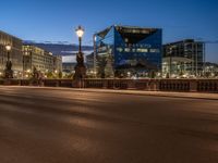 the city skyline is at night from the street level with traffic and pedestrians walking on it