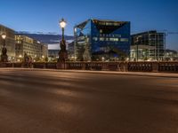 the city skyline is at night from the street level with traffic and pedestrians walking on it