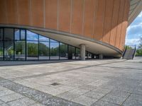 the entrance to an outside space with large windows and a view of mountains out to trees